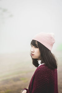 Portrait of a young woman looking away