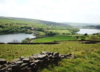 Scenic view of green landscape against sky