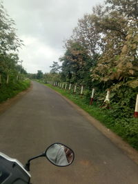 Street by road against sky