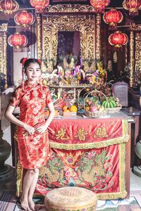 Full length portrait of woman standing in temple