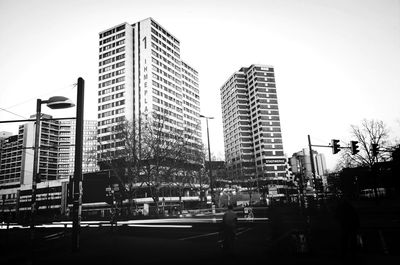Buildings in city against clear sky