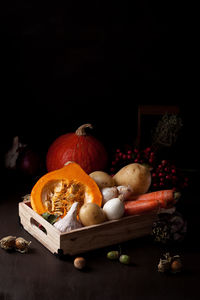 Close-up of pumpkins on table against black background