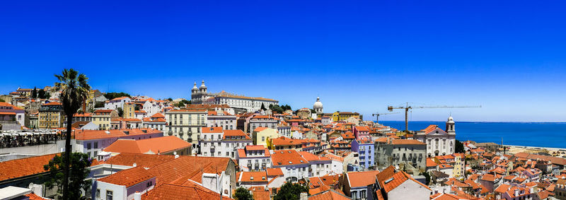 High angle shot of townscape against blue sky