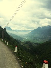 Scenic view of mountains against cloudy sky