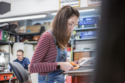 Woman looking at camera while standing in store
