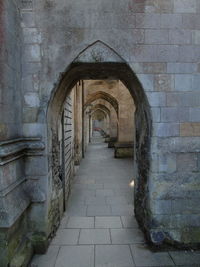 Archway leading towards stone wall