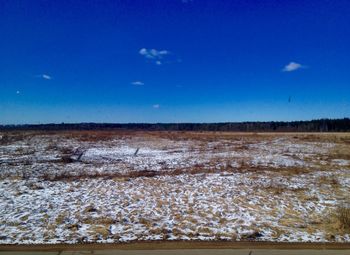 Scenic view of landscape against blue sky