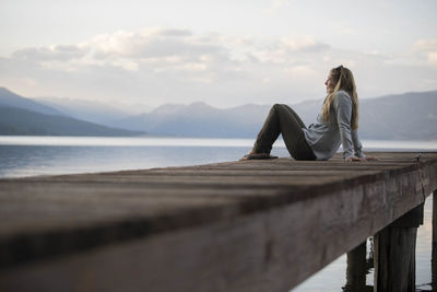 A woman enjoying an evening on the docks on hebgen lake.