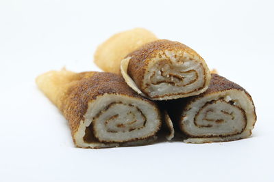Close-up of bread over white background