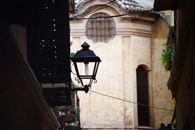 Low angle view of street light against building