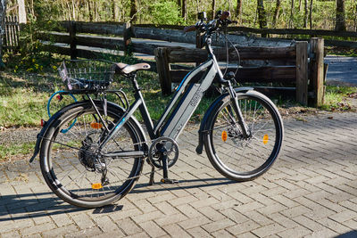Bicycle parked on footpath in park