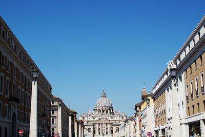 Low angle view of buildings against blue sky