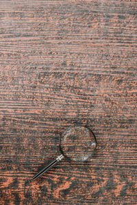 High angle view of metallic structure on wooden table