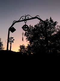 Low angle view of silhouette trees against clear sky