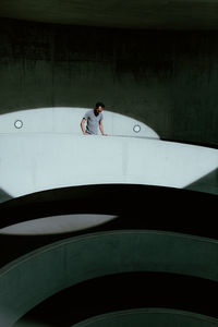 Mid adult man standing at building balcony