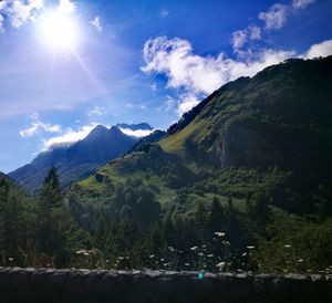 Scenic view of mountains against cloudy sky