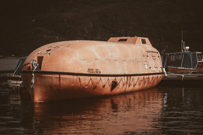 Abandoned boat moored in river