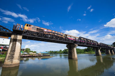 Low angle view of bridge over river against sky