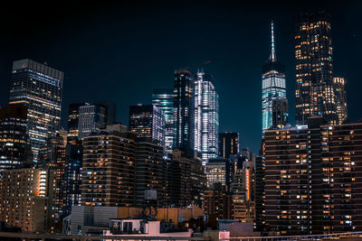 View of skyscrapers lit up at night