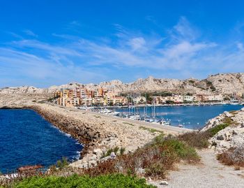 Panoramic view of beach and city against sky