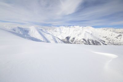 Scenic view of snowcapped mountains against sky