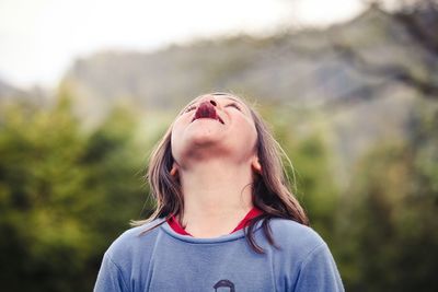 Close-up of a boy sticking out tongue