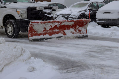 Snow covered car on street