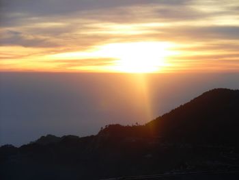 Scenic view of silhouette mountains against sky during sunset