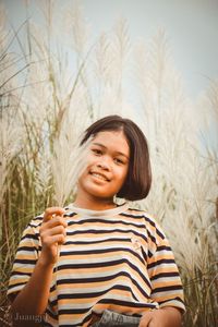 Portrait of teenage girl standing on field