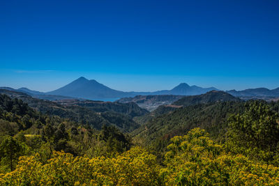 Scenic view of mountains against clear blue sky