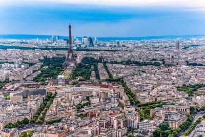 Eiffel tower amidst cityscape at dusk