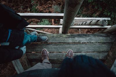 Low section of people standing on footbridge