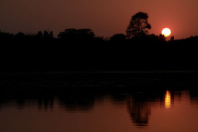 Scenic view of lake against sky at sunset