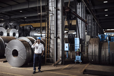 Rear view of man standing at industry