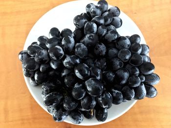 High angle view of blueberries in bowl on table