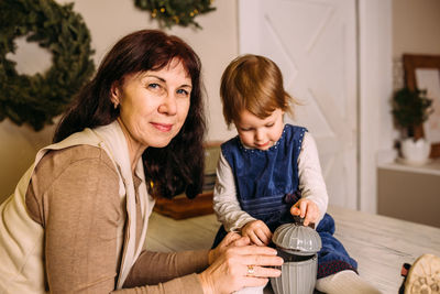 Grandmother and little granddaughter spend time together at christmas time.