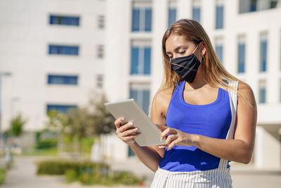 Midsection of woman using mobile phone