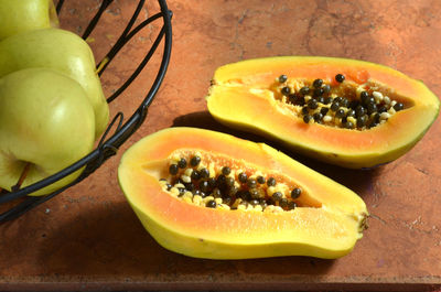 High angle view of granny smith apples and papaya on table