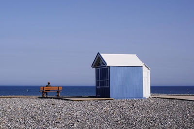 Lifeguard hut on beach against clear sky