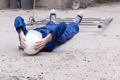 High angle view of boy lying down on street