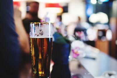 Close-up of beer glass on bar counter