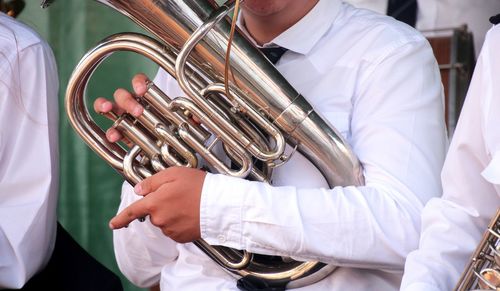 Close-up of boy playing tuba
