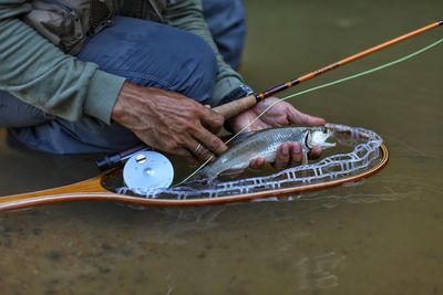 Midsection of man playing in water