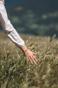 Low section of man standing on field