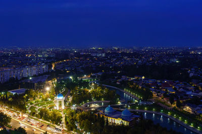 High angle view of illuminated cityscape against sky at night