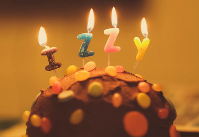 Close-up of burning birthday candles on cupcake