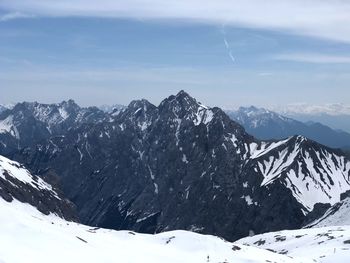 Scenic view of snowcapped mountains against sky