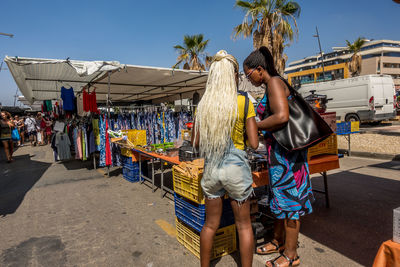 Rear view of people at market stall