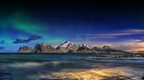 Scenic view of mountains against sky at night