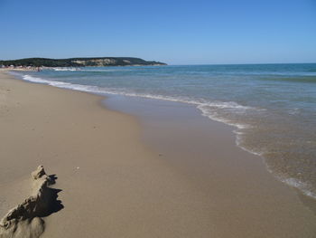 Scenic view of beach against clear sky